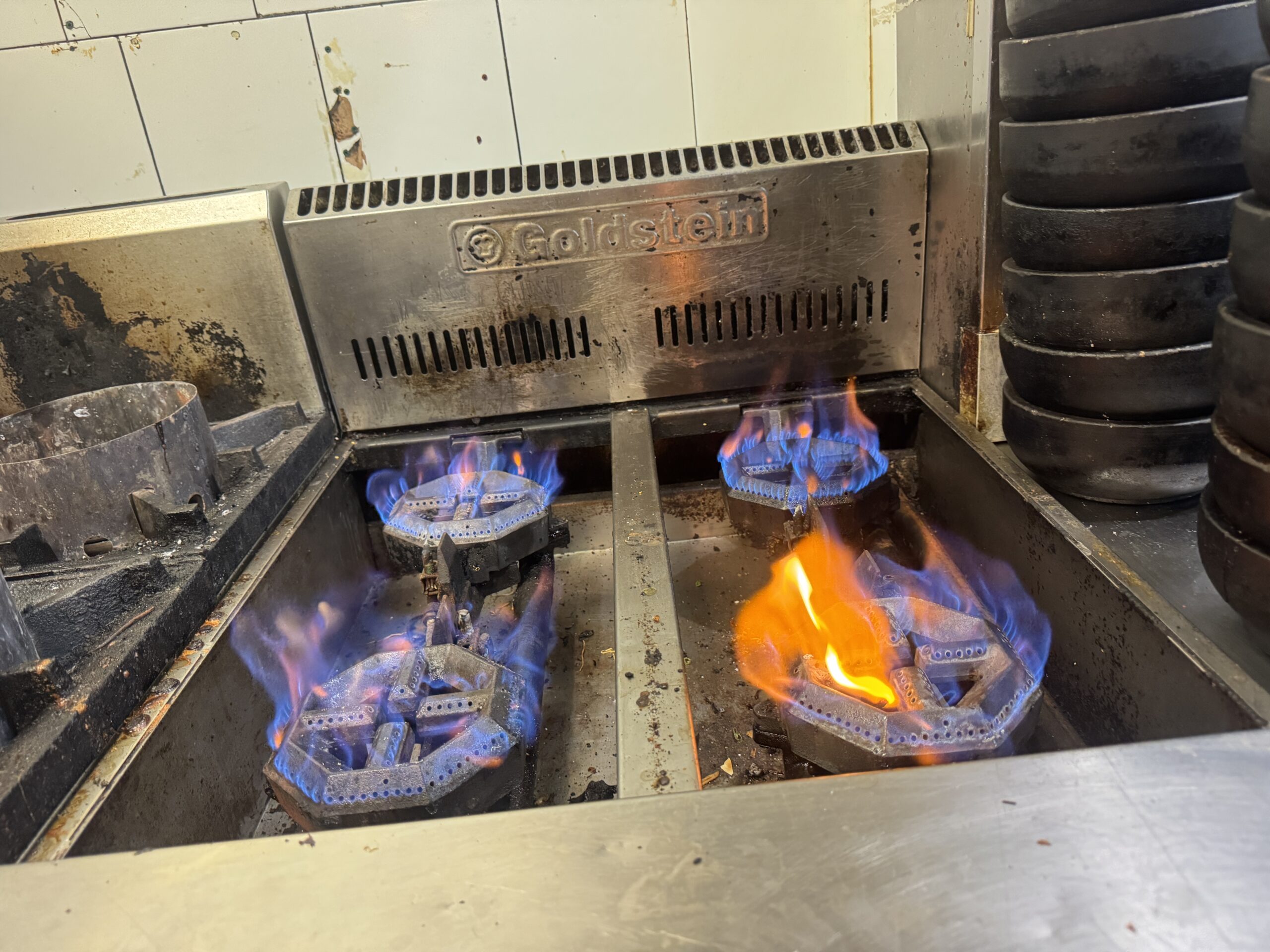 Gas range repair in restaurant kitchen